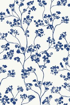 a blue and white floral wallpaper with small flowers on the top right side of it