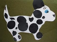 a paper cut out of a dog with blue eyes and black spots on it's face