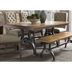 a dining room table with benches and chairs