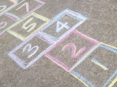 a child's drawing on the ground with colored crayons and chalk pastels