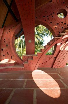 a red brick structure with circular windows in the center