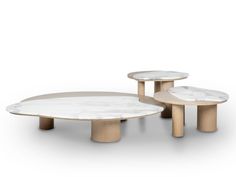 three tables with marble top and wooden bases, one on each side by the other