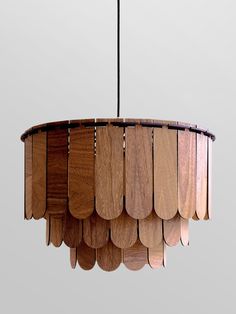 a chandelier made out of wooden planks hanging from a metal rod,