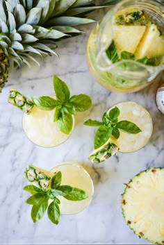 pineapple mojits with mint garnish on marble table