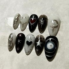 six different types of painted rocks sitting on a white surface with one candle in the middle