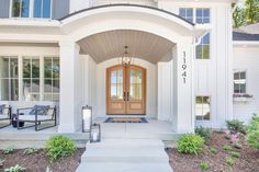 the front entrance to a home with steps leading up to it