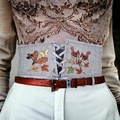 Transform your outfit into a stunning masterpiece with this custom embroidered wide corset belt!  Perfect for any Renaissance festival, this plus size underbust wide corset belt is designed to accentuate your curves while adding a touch of elegance to your ensemble.  The intricate lace-up detailing and linen construction make this piece a must-have for any fashion-forward individual looking to make a statement.  Elevate your look with this one-of-a-kind accessory that is sure to turn heads where Cottage Core Clothes, Embroidered Corset, Wide Belts For Women, Plus Size Corset, Waist Cincher Corset, Folk Clothing, Women Corset, Corset Belt, Underbust Corset