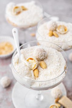 three desserts in glass dishes with white frosting and nuts on the top one is topped with powdered sugar