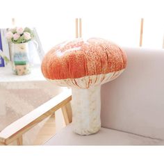 a mushroom shaped object sitting on top of a white couch