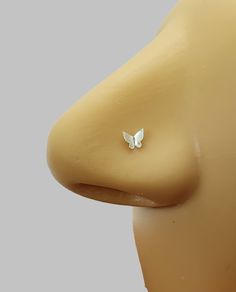 a close up of a plastic head with a butterfly on it's nose and ear