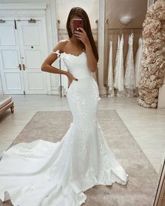 a woman taking a selfie in her wedding dress