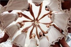 the bridesmaids are standing in a circle holding their hands together to form a star