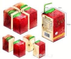 four pieces of red apple with green leafy stems in front of the box and side