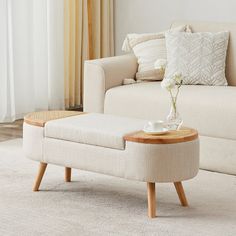 a living room scene with focus on the couch and coffee table in the centerpiece