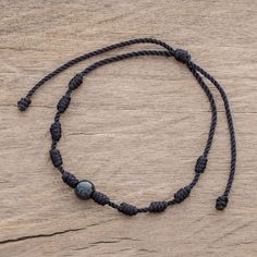 Rugged meets beautiful in this pendant bracelet designed by Ruben and Gilda Perez of Guatemala. A single bead of captivating black jade is centered on black nylon cord with evenly spaced cylindrical knots. The bracelet is easy to put on and fit to size thanks to a sliding knot closure. Black Bohemian Bracelet With Waxed Cord, Black Beaded Bracelet With Sliding Knot, Black Nylon Cord Jewelry As Gift, Black Nylon Cord Jewelry For Gift, Spiritual Hand-strung Jewelry In Waxed Cord, Adjustable Spiritual Waxed Cord Jewelry, Bohemian Black Waxed Cord Bracelets, Black Nylon Cord Casual Jewelry, Casual Black Nylon Cord Jewelry