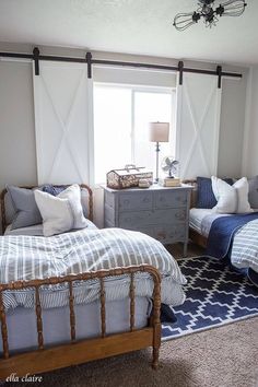 two twin beds in a bedroom with blue and white bedding