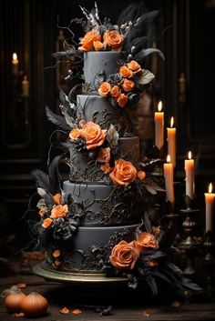 a three tiered cake with orange flowers and candles on the table next to it