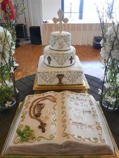 three tiered wedding cake sitting on top of a table