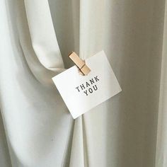 a thank you note attached to a white curtain