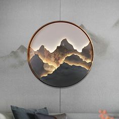 a round mirror hanging on the side of a wall next to a couch and table