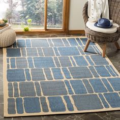 a blue and beige area rug in a living room