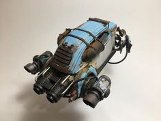 a toy car made out of metal and rusted to look like it has wheels