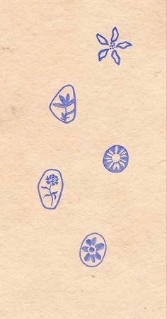 an old paper with blue ink on it and some drawings in the middle, including flowers