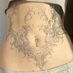 a woman's stomach with an intricate design on it