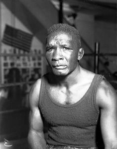 a black and white photo of a man in a tank top