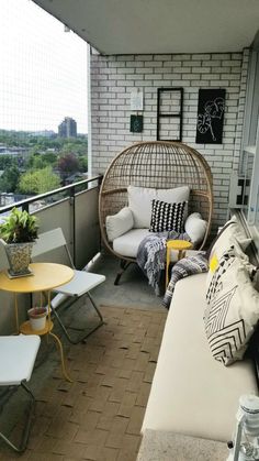 a living room filled with furniture on top of a balcony