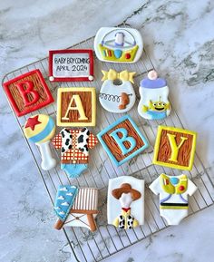 decorated cookies on a cooling rack for baby shower