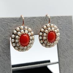 Elegant and eye-catching pair of Victorian style earrings.  A beautiful oval rosetta with two rows of freshwater white round pearls and natural red corals in the middle all tied on rose gold plated silver 925o.  The charming earrings have lever back closure that ensures stability while wearing them.  Elegant and luxury pair of earrings with natural Mediterranean corals and freshwater pearls. *Dimensions: H: 2.5 cm / 0.98 inches W: 1.7 cm / 0.66 inches Elegant Handmade Oval Pearl Earrings, Luxury Oval Jewelry For Opera, Elegant Oval Rose Gold Earrings, Elegant Red Cabochon Jewelry, Elegant Red Jewelry With Cabochon, Elegant Red Pearl Drop Jewelry, Elegant Handmade Oval Earrings, Elegant Hallmarked Jewelry For Opera, Elegant Cabochon Pearl Drop Earrings