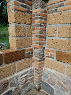 the corner of a brick wall made out of bricks