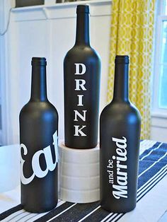 three black bottles sitting on top of a table