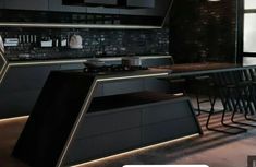 a modern kitchen with black cabinets and counter tops