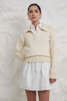 A soft and comfortable sweater to take you through the seasons. The breathable knit fabric means you can wear this ivory sweater on its own with shorts during warmer months, or you can layer it and style it with your favorite trousers when it's cold. A classic silhouette, you can pair this sweater with all of your favorite bottoms. For a comfortable and casual look, wear this sweater with some high-waisted jeans and your favorite sneakers. Knit Collar Drop shoulder V neckline Long sleeves Ribbed Ivy Clothing, Summer Style Guide, Collared Sweater, Faux Shearling Jacket, Casual Party Dresses, Knit Outerwear, Ivory Sweater, Balloon Sleeve Blouse, Comfortable Sweater