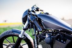 a black motorcycle parked on the side of a road