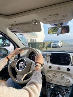 a woman driving a car on the road