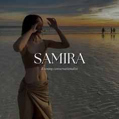 a woman standing on top of a beach next to the ocean