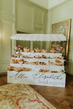 there is a sign that says the establishment boulangerie in front of some pastries