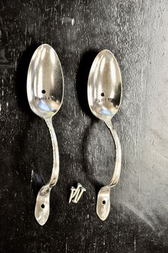 two spoons sitting next to each other on a table