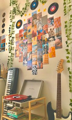 the wall is decorated with many pictures and musical instruments, including an electric guitar in front of a record player