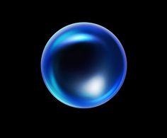 a blue bubble floating in the air on a black background