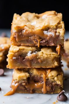 chocolate chip cookie bars stacked on top of each other with drizzled caramel