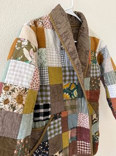 a patchwork jacket hanging on a wall