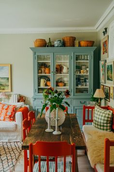 a dining room table with chairs and a hutch in the backround area