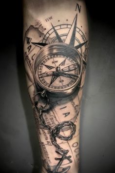 a man's leg with a compass and chain tattoo on the calf area is shown