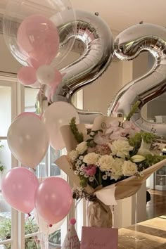 balloons and flowers are hanging from the ceiling