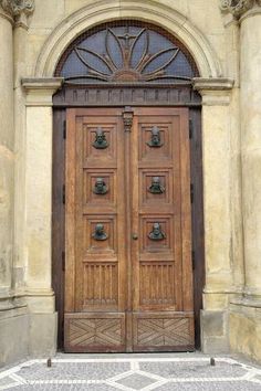 an old wooden door with ornate carvings on the front and side doors are open to let in light