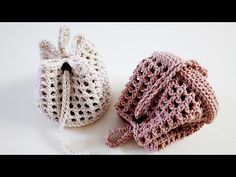 two crocheted bags sitting next to each other